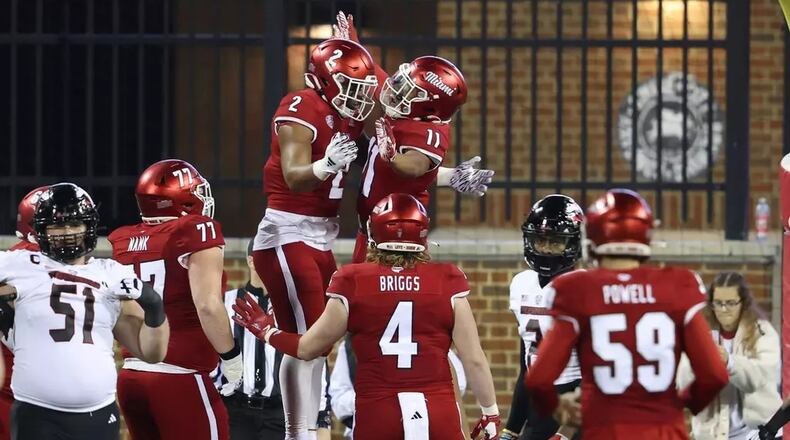 Miami’s Javon Tracy (11) and Dylan Downing (2) celebrate after the RedHawks scored a touchdown against Northern Illinois last week at Yager Stadium. Miami Athletics photo