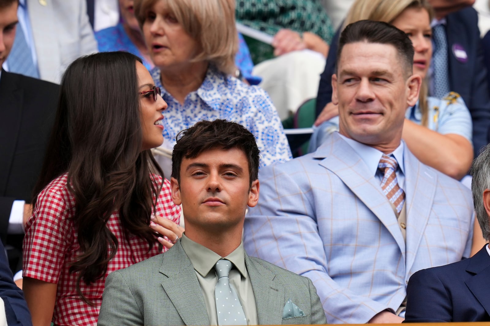 Olympic gold medallist Tom Daley, center, and wrestler John Cena sit in the Royal Box at Centre Court during the Wimbledon Tennis Championships in London, Wednesday, July 2, 2025.(AP Photo/Kirsty Wigglesworth)