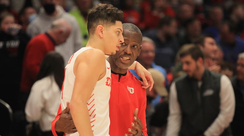 Dayton's Anthony Grant, right, talks to Koby Brea during a game against St. Bonaventure on Tuesday, Jan. 18, 2022, at UD Arena. David Jablonski/Staff