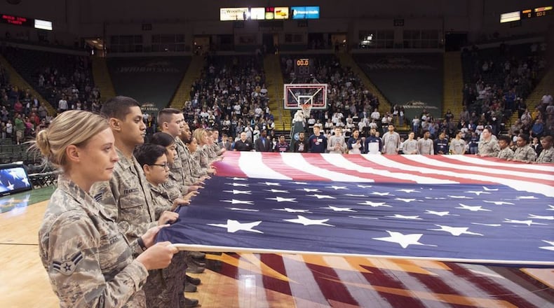 Airmen from Wright-Patterson Air Force Base hold a large American flag during a pregame ceremony prior to a Wright State University basketball game Jan. 26 at the Nutter Center. The college hosted a military appreciation night. (U.S. Air Force photo/R.J. Oriez)