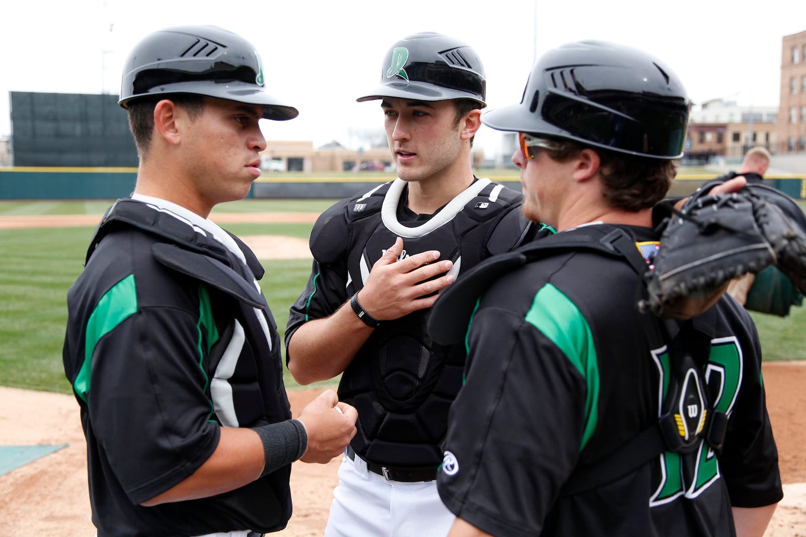 Dayton Dragons catching staff Julio Morillo, left, Joe Hudson and Brandon Dailey at practice before opening day on April 2, 2014 at Day Air Ballpark. TY GREENLEES / STAFF