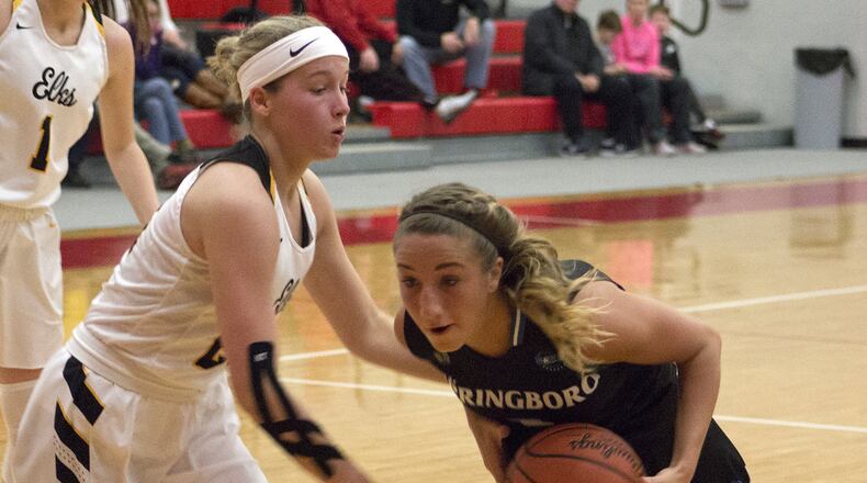Springboro’s Maddy Bakosh drives on Centerville’s Kelsey George on Monday night during Centerville’s 65-63 victory in a Division I sectional final at Troy High School. Jeff Gilbert/CONTRIBUTED