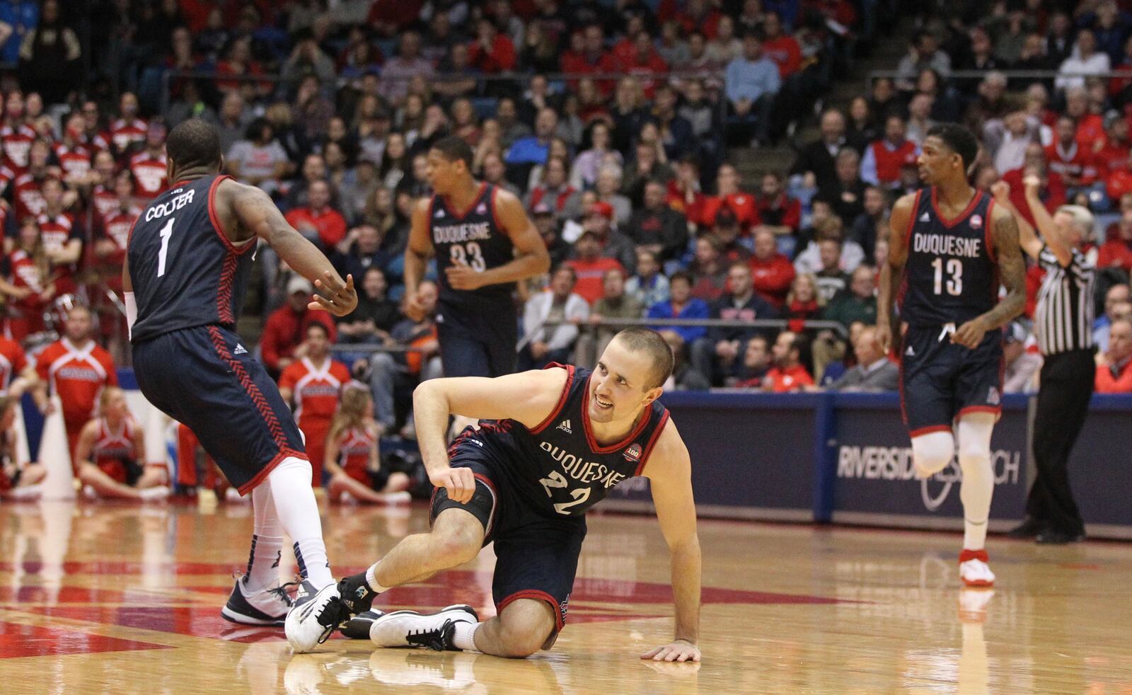 Duquesne's Micah Mason gets up after making a 3-pointer to give Duquesne a 12-point lead in the second half on Tuesday, Feb. 9, 2016, at UD Arena in Dayton. David Jablonski/Staff