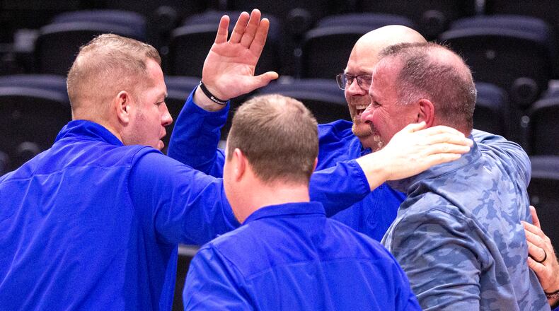 Russia coaches Brad Francis, right, Spencer Cordonnier, center, Nick Leffel, left, and Cody Anthony celebrate together after their team defeated Catholic Central last week in a Division IV district final at UD Arena. CONTRIBUTED/Jeff Gilbert