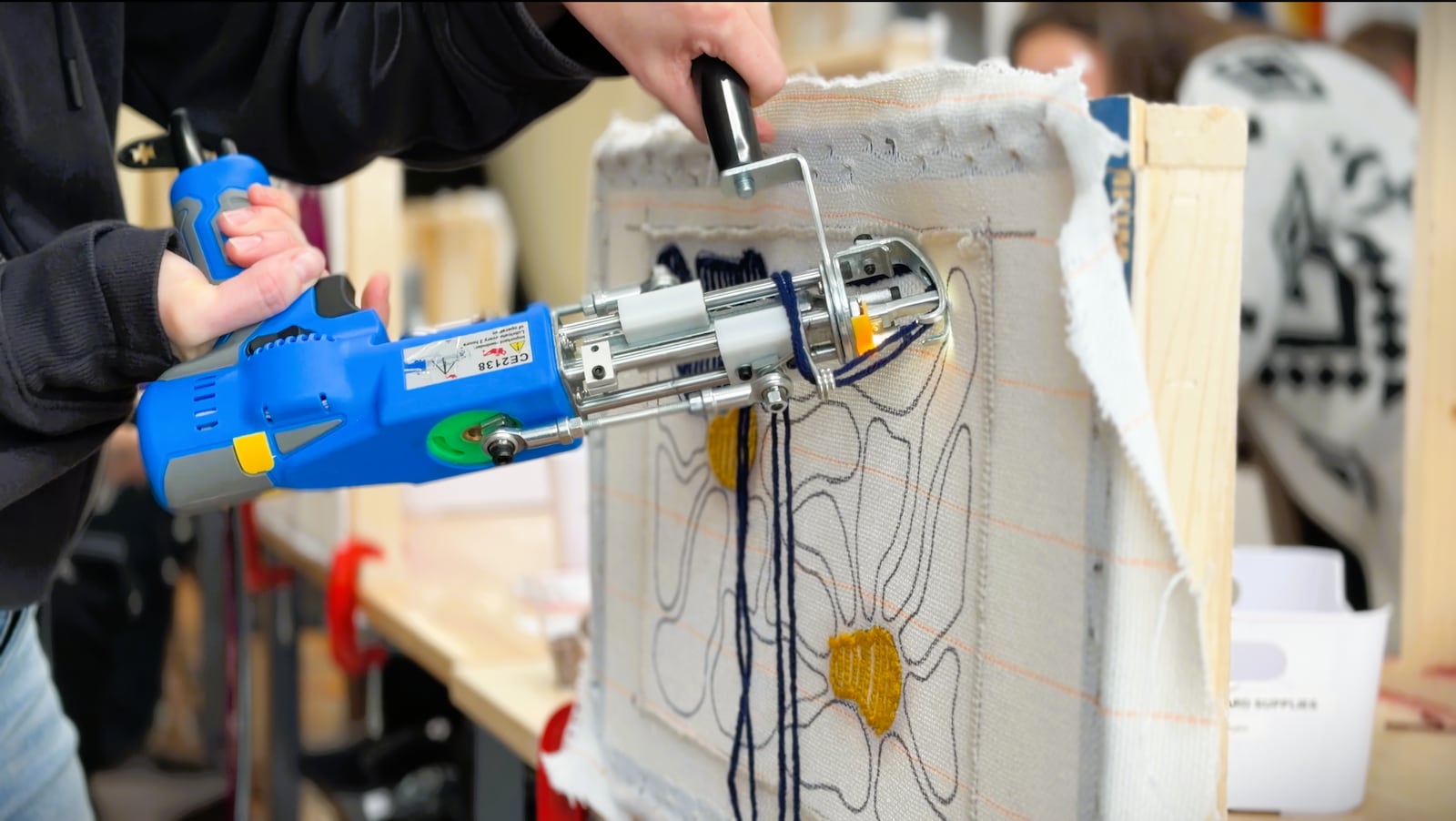 Customers at Common Thread Fiber Art Studio in Xenia use a tufting gun to punch yarn through a canvas backing, creating a rug, November 21, 2025. DAVID SHERMAN/STAFF