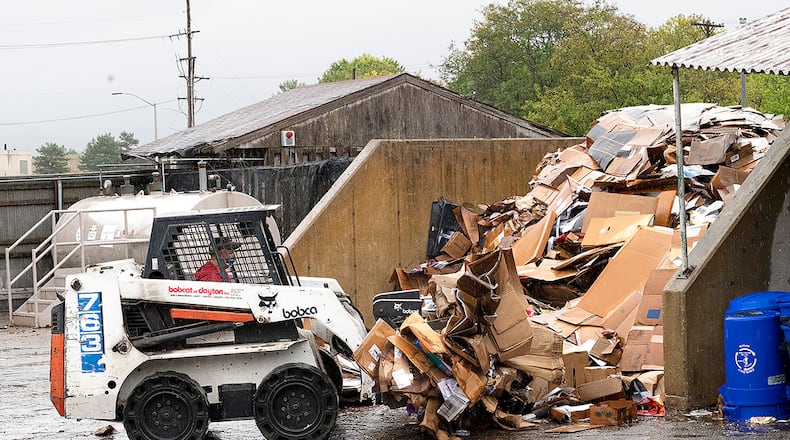 Dave Matheney, 88th Force Support Squadron, scoops up a load of cardboard Sept. 22 to be sorted at the Wright-Patterson Air Force Base Recycling Center. The cardboard mound needs to be hand sorted to remove trash and paper that belongs in another bin. U.S. AIR FORCE PHOTO/R.J. ORIEZ