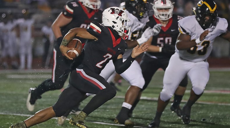 Wayne's Bryan Kinley breaks into the Centerville secondary as he carries the ball during Friday's game. BILL LACKEY/STAFF