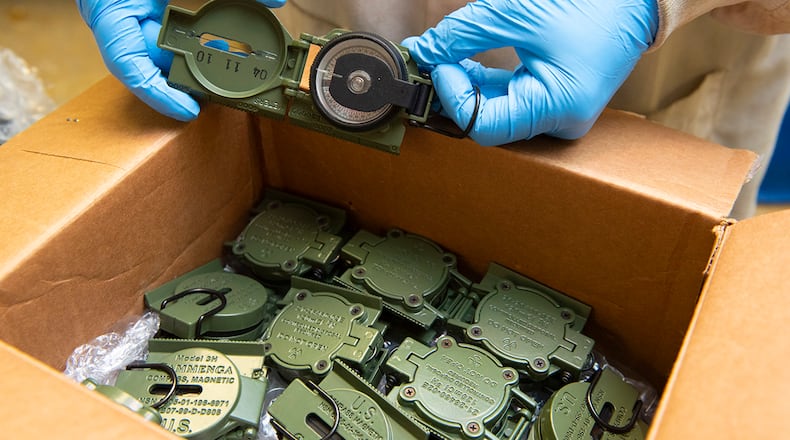 Seth Walton displays a lensatic compass shipped to the Air Force Radioactive Recycling and Disposal facility Dec. 1 at Wright-Patterson Air Force Base. U.S. AIR FORCE PHOTO/JAIMA FOGG