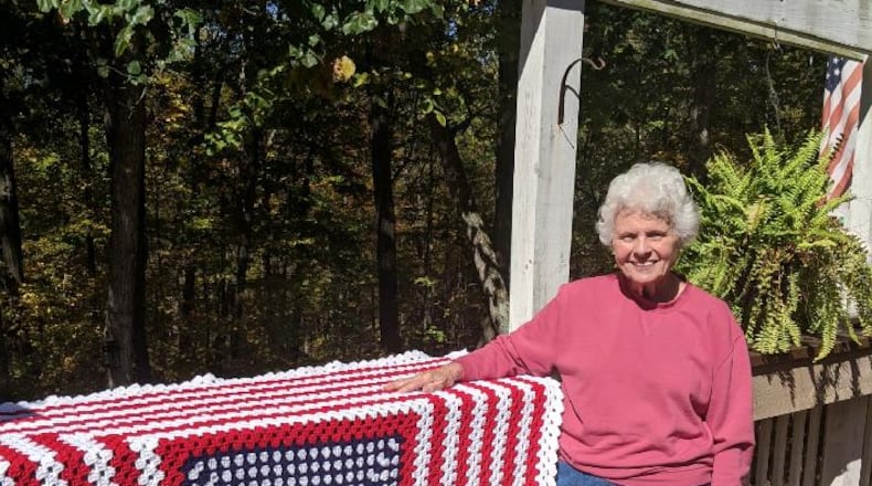 Breast cancer survivor Janet "Jan" Clements of Springdale with one of the afghans she made for the veterans. CONTRIBUTED