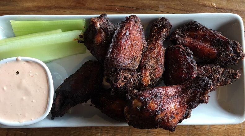 Lock 27’s signature dry rubbed, house smoked chicken wings, served with celery and house made sriracha blue cheese, come two ways — a hot habanero-peach rub or a dry sweet and spicy rub. CONTRIBUTED/ALEXIS LARSEN