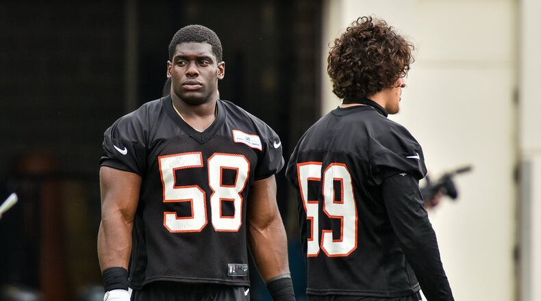 Bengals linebacker Carl Lawson (left) suffered a season-ending ACL tear. NICK GRAHAM/STAFF