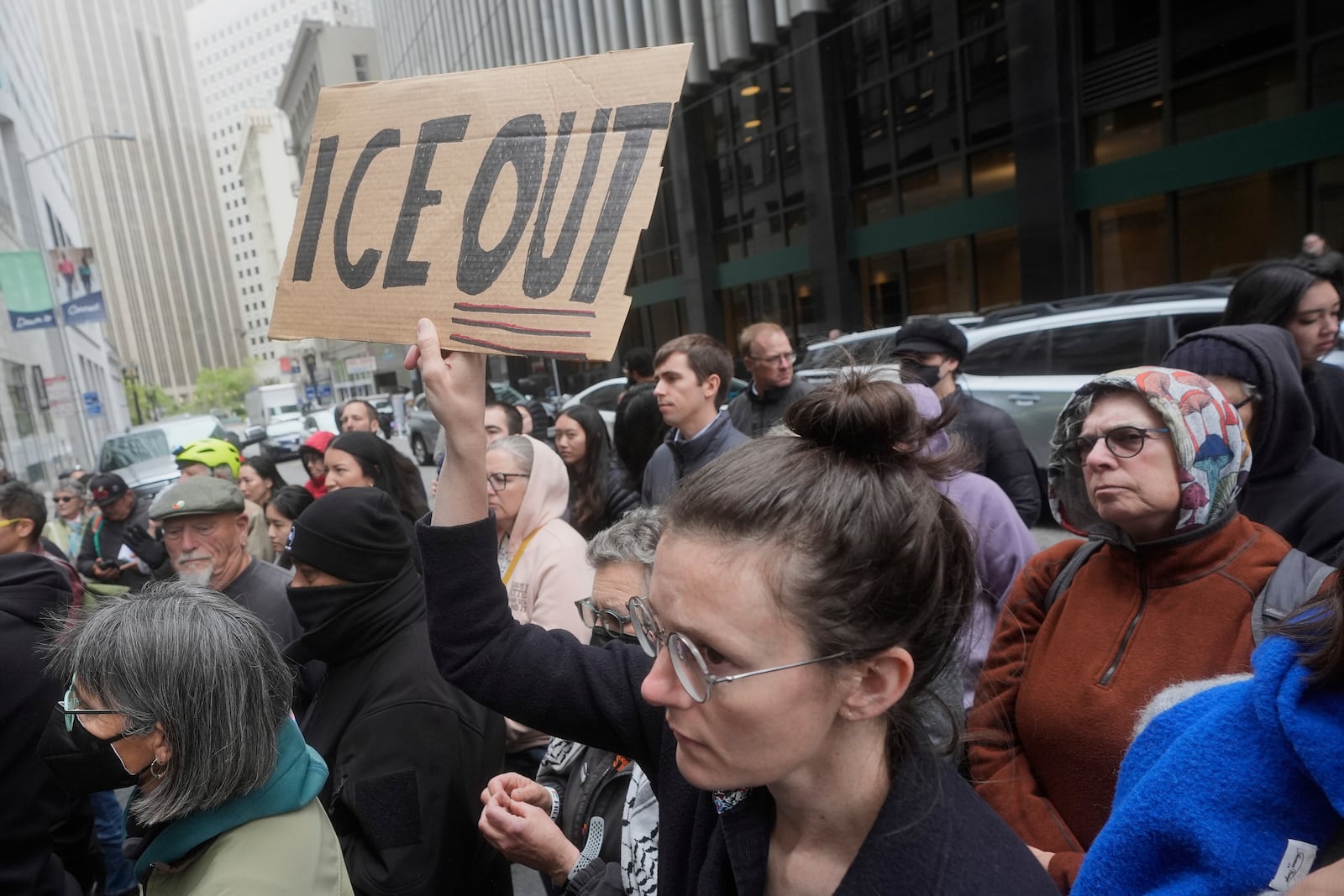 A person holds up a sign during a news conference and rally by immigrant justice organizations and advocates protesting ICE arrests in San Francisco, Wednesday, May 28, 2025. (AP Photo/Jeff Chiu)