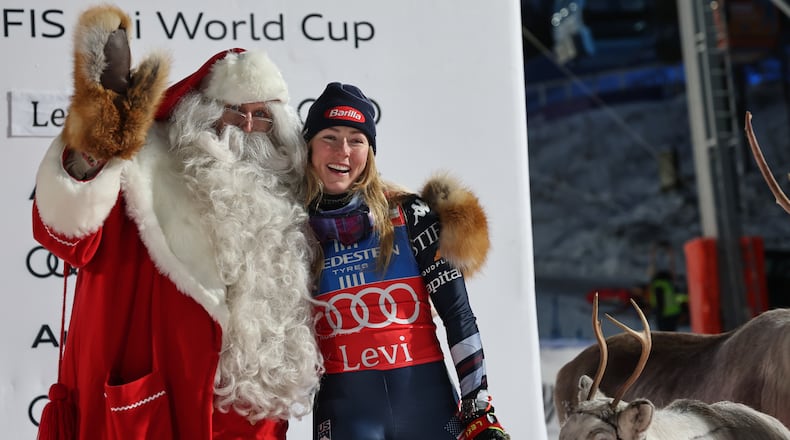 FILE - United States' Mikaela Shiffrin poses with Santa Claus as she celebrates on the podium after winning an alpine ski, women's World Cup slalom, in Levi, Finland, on Nov. 15, 2025. (AP Photo/Marco Trovati, File)