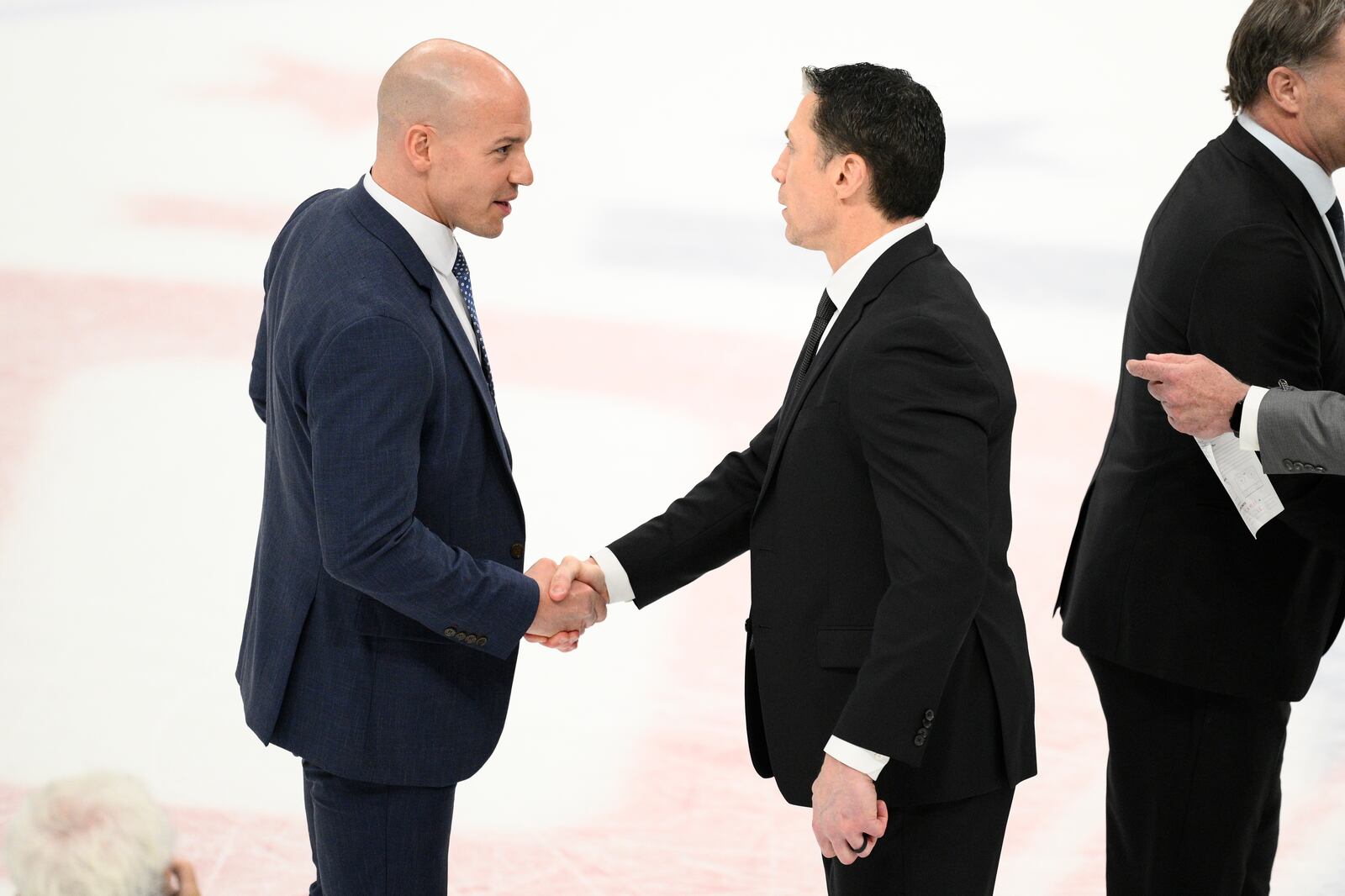 Carolina Hurricanes head coach Rod Brind'Amour, right, and Washington Capitals head coach Spencer Carbery, left, shake hands after Game 5 of a second-round NHL hockey playoff series Thursday, May 15, 2025, in Washington. (AP Photo/Nick Wass)