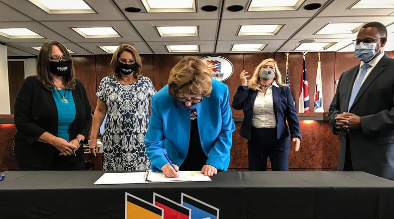 Montgomery County Commission President Judy Dodge signs a new Children Services union contract on Tuesday, Sept. 15, 2020. JIM NOELKER / STAFF