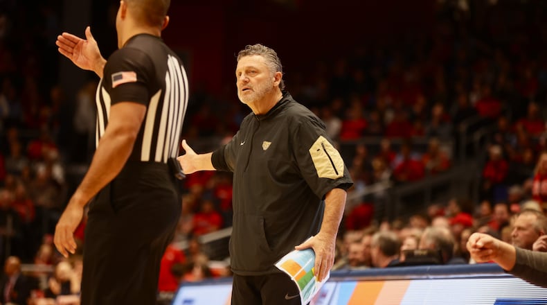 Oakland's Greg Kampe talks to an official during a game against Dayton on Wednesday, Dec. 20, 2023, at UD Arena. David Jablonski/Staff