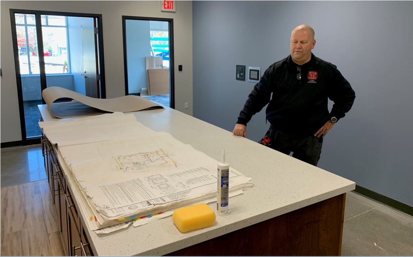 Lebanon Fire & EMS Chief Steven Johnson looks over the new plans examining area at Station 41. ED RICHTER/STAFF