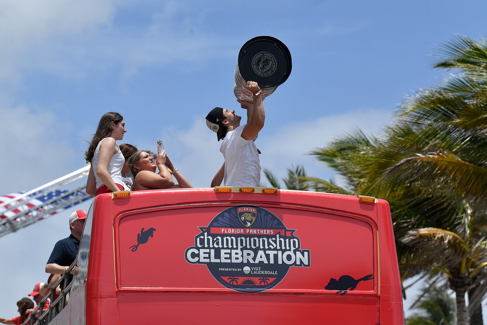 Florida Panthers' Mackie Samoskevich hoists the Stanley Cup during the NHL hockey team's Stanley Cup championship celebration, Sunday, June 22, 2025, in Fort Lauderdale, Fla. (AP Photo/Michael Laughlin)