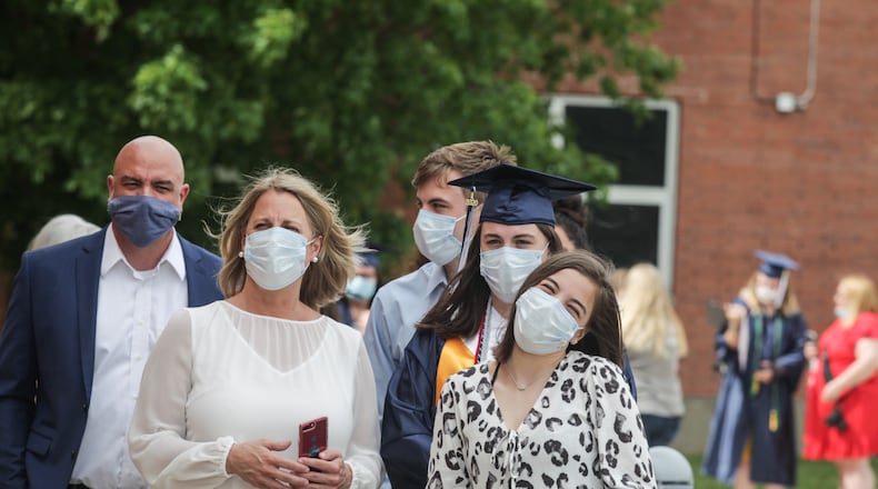 In May, Fairmont High School seniors picked up their diplomas in a ceremony changed because of the coronavirus pandemic. More than 500 graduates waited in theirs cars for their names to be called. After receiving their diploma, the students entered the school's atrium for pictures. JIM NOELKER/STAFF