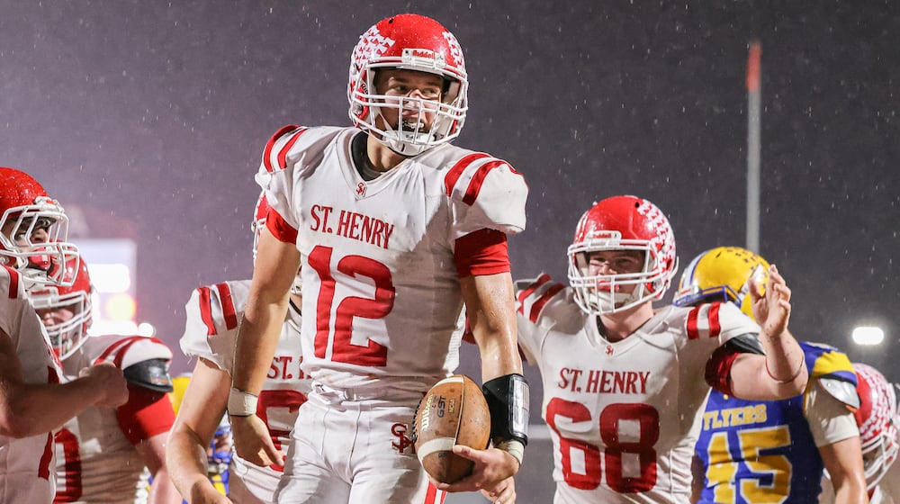 St. Henry senior quarterback Charlie Werling celebrates after a short touchdown run in the third quarter of the Division VII, Region 28 championship game on Friday, Nov. 21 at Mercy Health/Wapak VFW Field in Wapakoneta. Werling scored four TDs to help the Redskins win 24-7 and snap a 76-game winning streak by the Flyers. BRYANT BILLING/STAFF