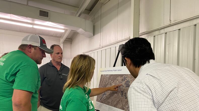 Locals speak with Dylan Stickney, right, about the proposed solar power project in Greene County. Eileen McClory / Staff
