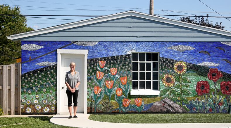 Guustie Alvarado, a Tipp City artist, spent a year creating “Covid Wall,” a glass mosaic on her garage. The artwork is filled with images meaningful to her life experience. Alvarado will be a presenter at PechaKucha Night Dayton on Wednesday, Sept. 1. The event will be held downtown at the Levitt Pavilion and begins at 7:30 p.m. LISA POWELL / STAFF