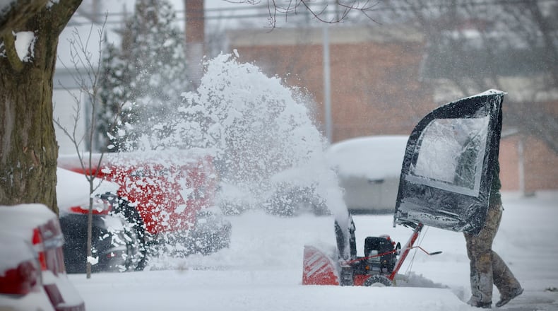 You could hear the sounds of snowblowers running all over the area Monday, Jan. 6, 2025, in Fairborn, like this man clearing sidewalks on Wayne Drive. MARSHALL GORBY/STAFF