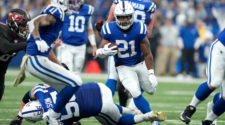 Indianapolis Colts running back Zack Moss (21) runs the ball during the second half of an NFL football game against the Tampa Bay Buccaneers Sunday, Nov. 26, 2023, in Indianapolis. (AP Photo/Michael Conroy)