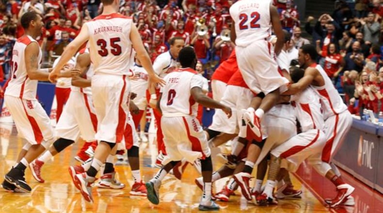The Flyers celebreate after a 3-pointer by Jordan Sibert with 1 second left beat IPFW 81-80 on Saturday, Nov. 9, 2013, at UD Arena.