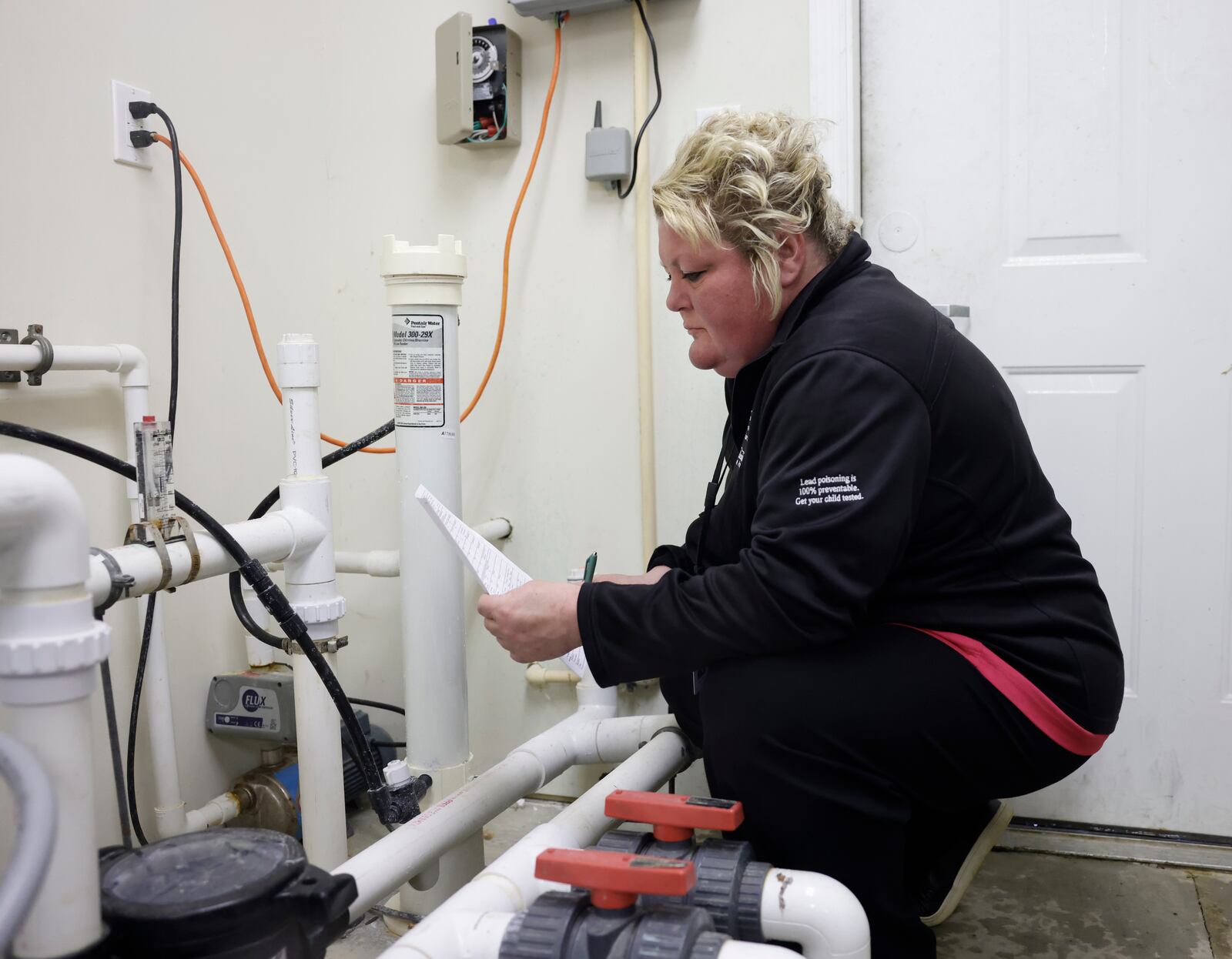 Emily Grieser, environmental health inspector of the Clark County Combined Health District, inspects equipment to make sure it's not infecting the pool on Tuesday, May 20, 2025, at Spring Meadow Apartments. JOSEPH COOKE/STAFF