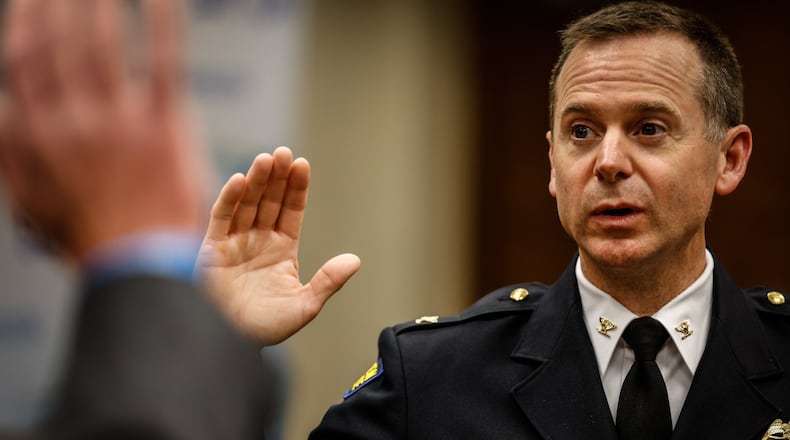 Matt Carper was sworn in as Dayton interim director and chief of police Friday July 30, 2021 by Deputy City Manager Joe Parlette. Police Chief Richard Biehl retired this week after leading the department for more than 13 years.  JIM NOELKER/STAFF