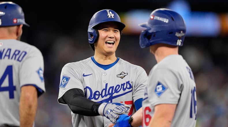 Los Angeles Dodgers' Shohei Ohtani and Will Smith talk during the eighth inning in Game 6 of baseball's World Series against the Toronto Blue Jays, Friday, Oct. 31, 2025, in Toronto. (AP Photo/Brynn Anderson)