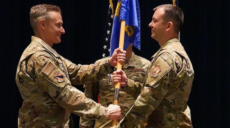 Col. Christian Lyons (left), 88th Medical Group commander, passes the 88th Dental Squadron guidon to Col. Nathan Krivitzky during a change of command ceremony June 23 at Wright-Patterson Medical Center. Krivitzky previously served as 88 DS residency director. He assumes command from Col. Jennie Stoddart, who’s leaving for Barksdale Air Force Base, Louisiana, to become the 2nd Dental Squadron commander. U.S. AIR FORCE PHOTO/KENNETH STILES