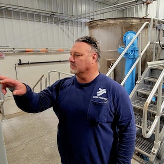 Yellow Springs Utility Operator Jeff Horn at work at the Yellow Springs village water filtration plant, Feb. 6, 2026. The tanks in the background are used to filter water through a combination of quartz sand and a chemical base to pull calcium and other particles out of residents' drinking water. LONDON BISHOP/STAFF