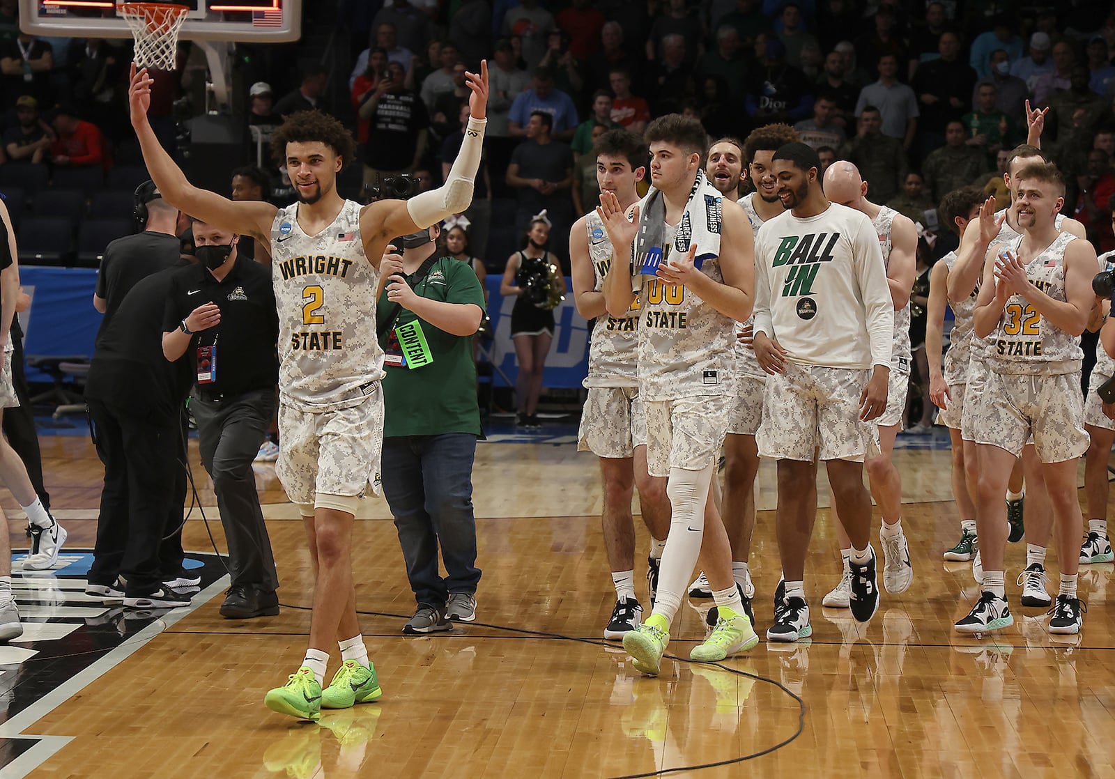 The Wright State Raiders, led by Tanner Holden, march off the court victorious Wednesday, March 16, 2022 after defeating Bryant in the First Four game. BILL LACKEY/STAFF