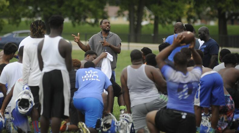 Dayton Public Schools soon will begin a new procedure for hiring coaches. Last year, the school board went through significant debate before retaining Dunbar head football coach Darran Powell. MARC PENDLETON / STAFF