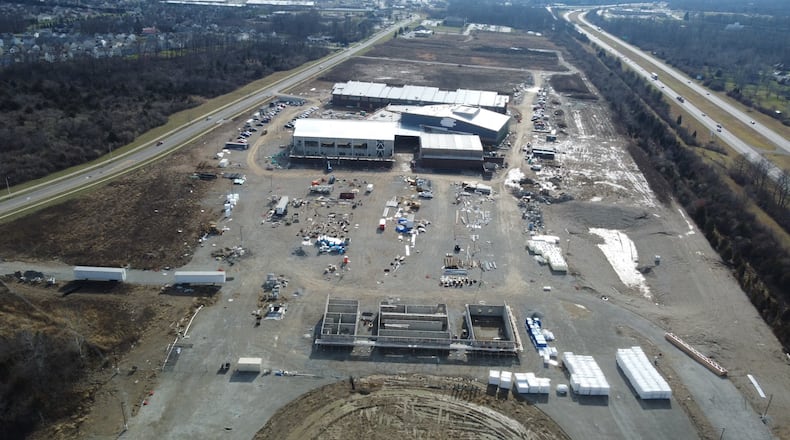 Fairborn plans to repave Commerce Center Boulevard (left), site of the new Fairborn High School now under construction near I-675 (right). CONTRIBUTED