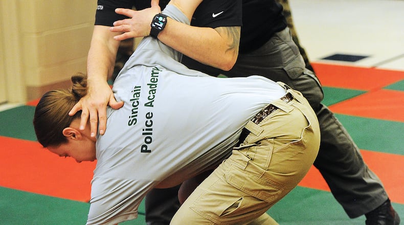 Instructor JP Kotronis demonstrates a takedown on reporter London Bishop. MARSHALL GORBY\STAFF