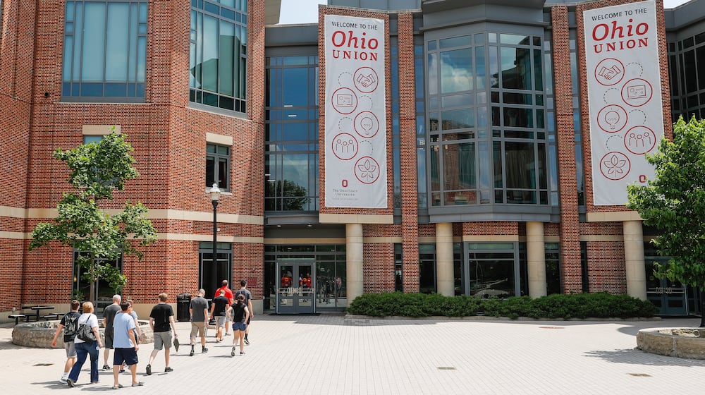 FILE -Pedestrians walk up to the The Ohio State University's student union, Saturday, May 18, 2019, in Columbus. (AP Photo/John Minchillo, File)