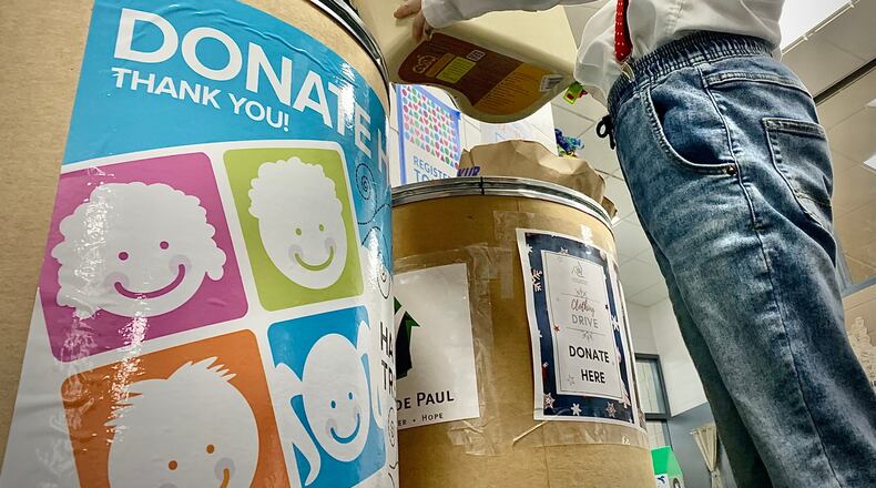 Stingley Elementary third grader Charlie Scrivner, age 8, makes a donation to Hannah’s Treasure Chest at his school Friday Feb. 11, 2022. MARSHALL GORBY\STAFF