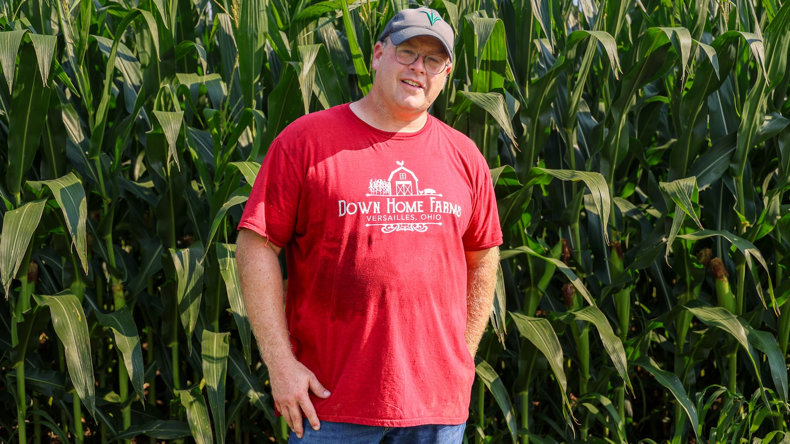 Greg McGlinch poses in front of corn at Down Home Farms, which he and his family operate northwest of Versailles. McGlinch, who is a fifth-generation farmer, said the crop has grown well this year and last. BRYANT BILLING / STAFF