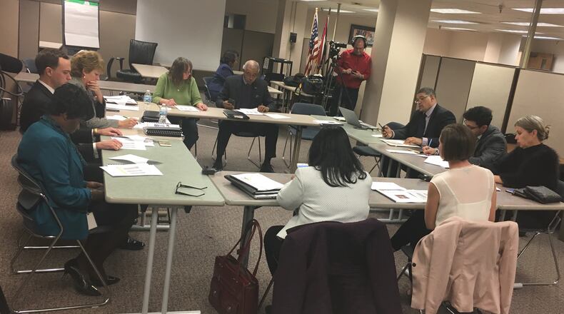 Current and incoming Dayton school board members discuss leadership roles for 2018 on Tuesday, Dec. 19. JEREMY P. KELLEY / STAFF