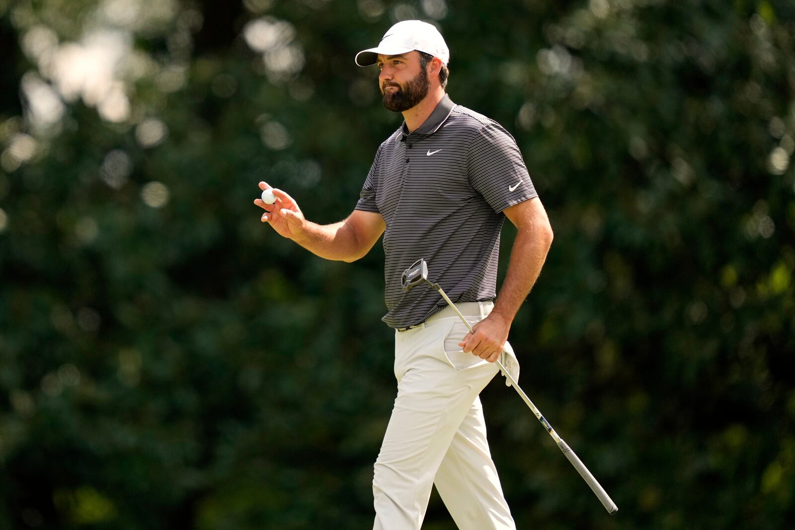Scottie Scheffler waves after making a putt on the fifth hole during the third round at the Masters golf tournament, Saturday, April 12, 2025, in Augusta, Ga. (AP Photo/Julia Demaree Nikhinson)