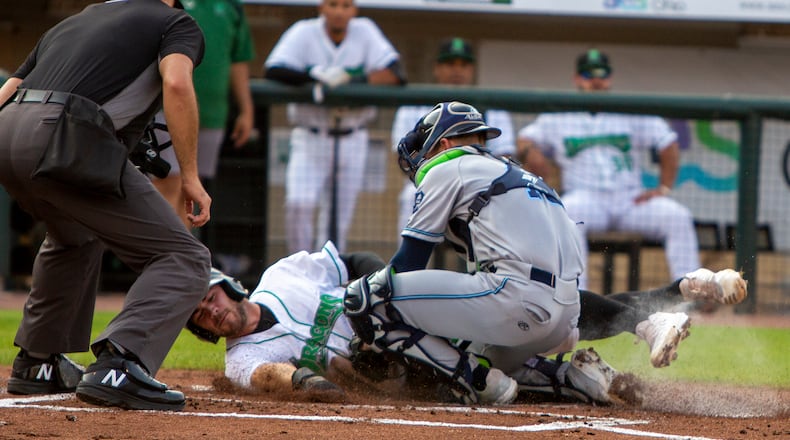 Dayton's Mike Siani is tagged out by West Michigan's Cooper Johnson in the first inning of Tuesday night's game at Day Air Ballpark. Siani tried to score from second base on a single by Quin Cotton. Jeff Gilbert/CONTRIBUTED