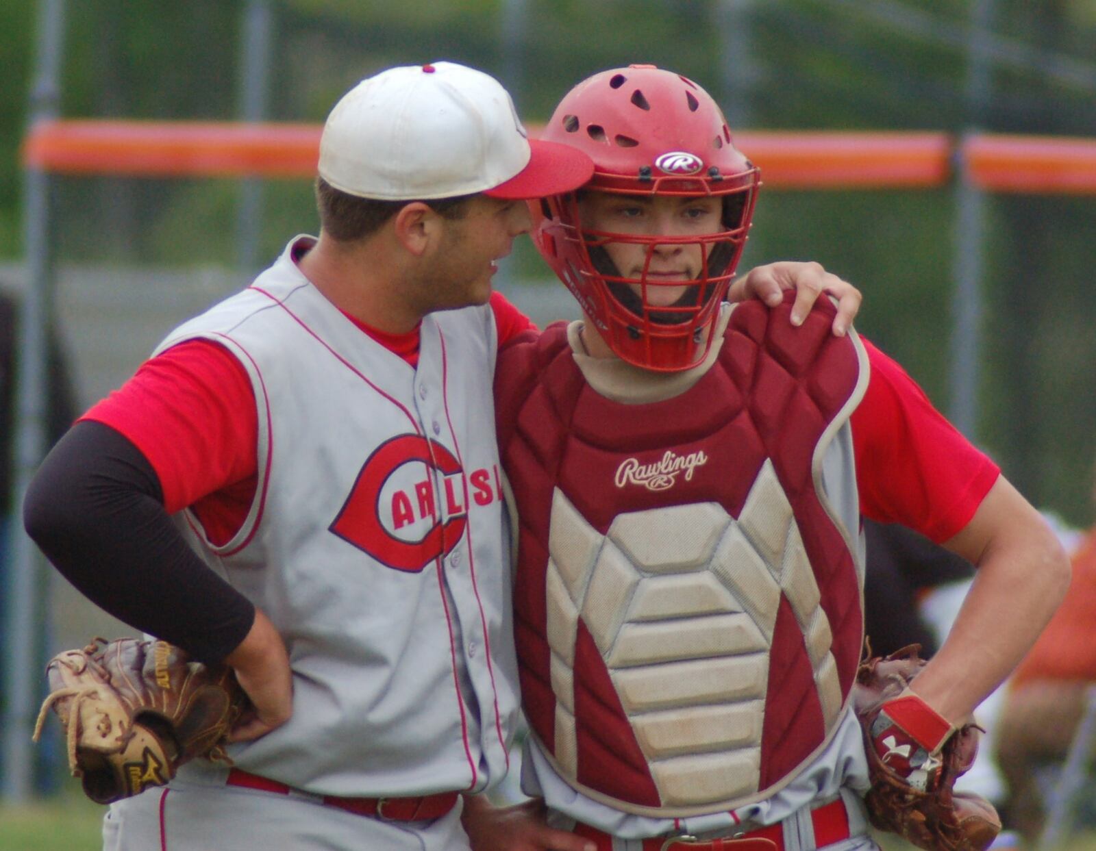 Carlisle pitcher Jake Glover (left) talks with catcher Dane Flatter during the second inning of Wednesday’s game at Waynesville. CONTRIBUTED PHOTO BY JOHN CUMMINGS