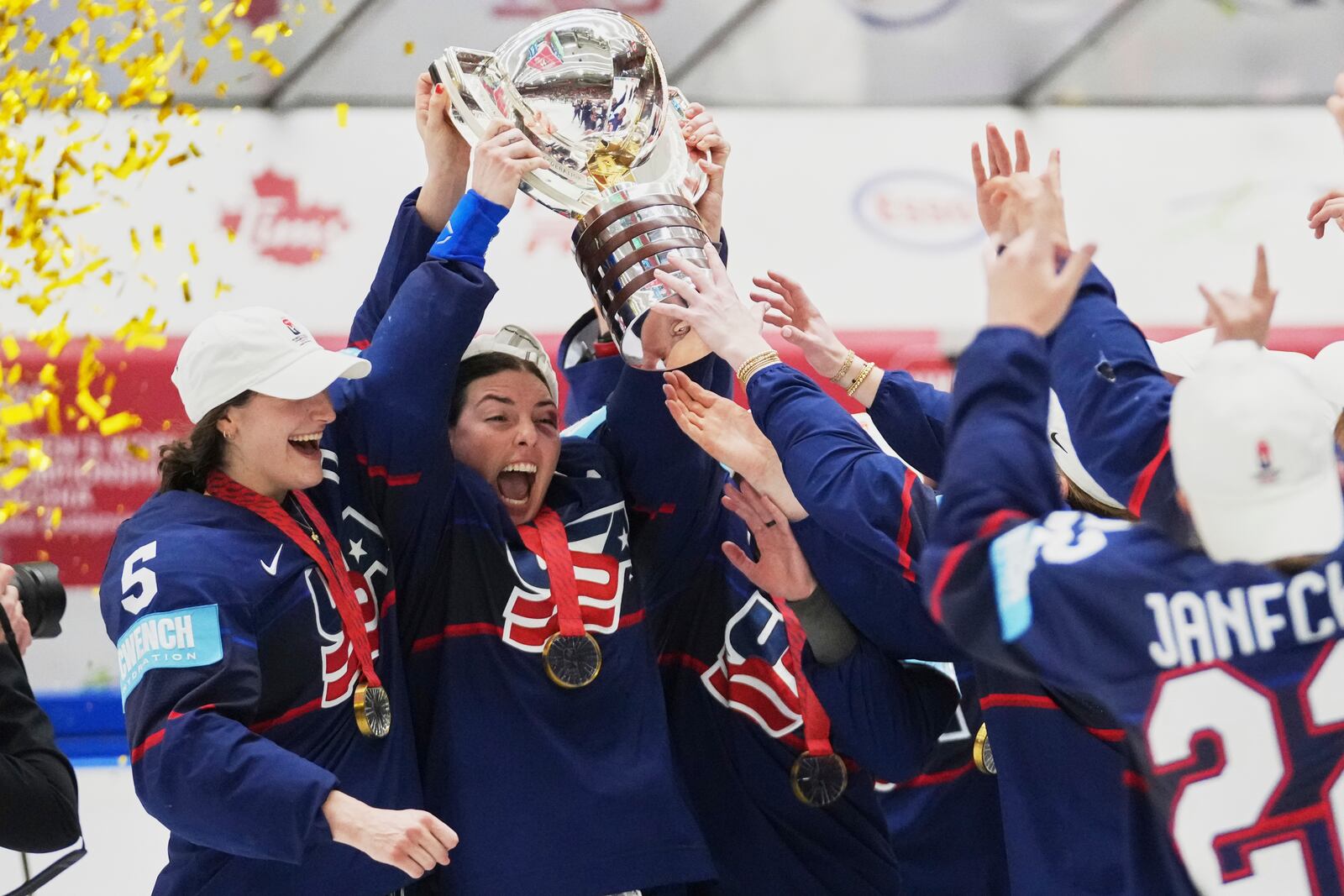 United states players celebrate with a trophy after the gold medal match between Canada and United States at the Women's Ice Hockey Championships in Ceske Budejovice, Czech Republic, Sunday, April 20, 2025. (AP Photo/Petr David Josek)