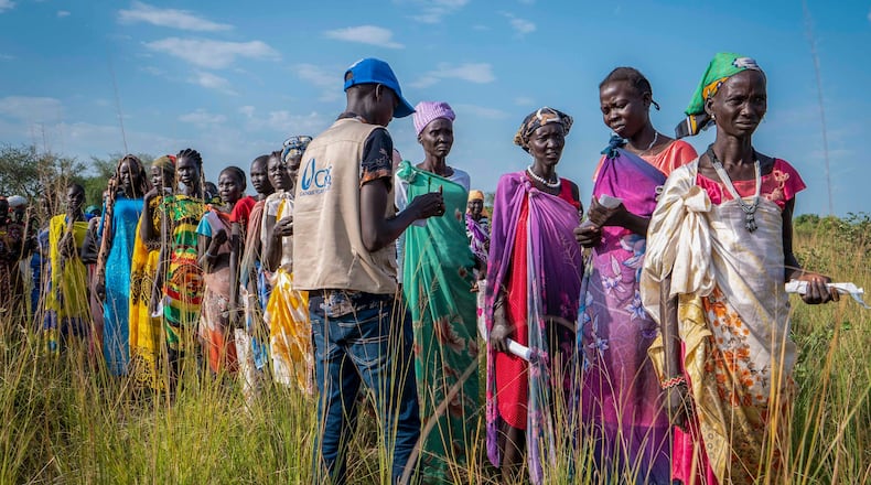 FILE - South Sudanese women line up for food rations at a World Food Programme (WFP) distribution point organized by Catholic Relief Services in Jonglei state, South Sudan, Wednesday, Nov. 13, 2024. (AP Photo/Florence Miettaux, File)