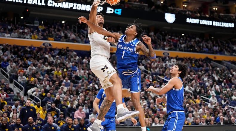 Michigan forward Yaxel Lendeborg (23) dunks over Saint Louis guard Quentin Jones (1) during the second half in the second round of the NCAA college basketball tournament, Saturday, March 21, 2026, in Buffalo, N.Y. (AP Photo/Yuki Iwamura)