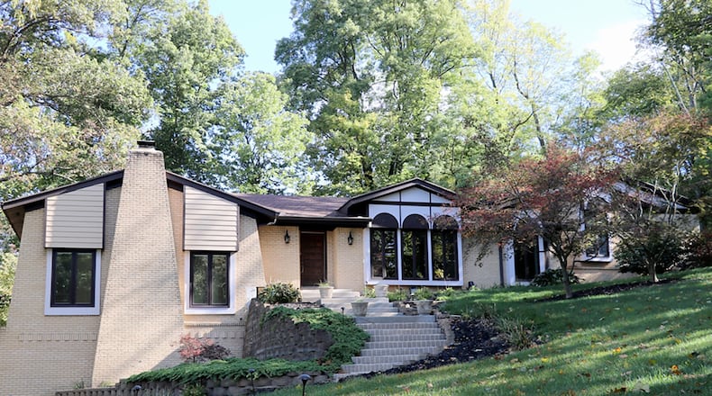 The brick, home has about 5,120 sq. ft. of living space with 4 or 5 bedrooms, great room and enclosed porch. A keystone-trimmed driveway and rolling front yard gives the property a brick ranch look, but the home is a quad-level design. CONTRIBUTED PHOTO BY KATHY TYLER