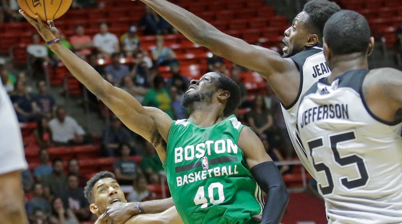 Boston Celtics guard Scoochie Smith (40) lays the ball up as San Antonio Spurs forward Livio Jean-Charles, right rear, and forward Cory Jefferson (55) defend during the first half of an NBA summer league basketball game Wednesday, July 5, 2017, in Salt Lake City. (AP Photo/Rick Bowmer)